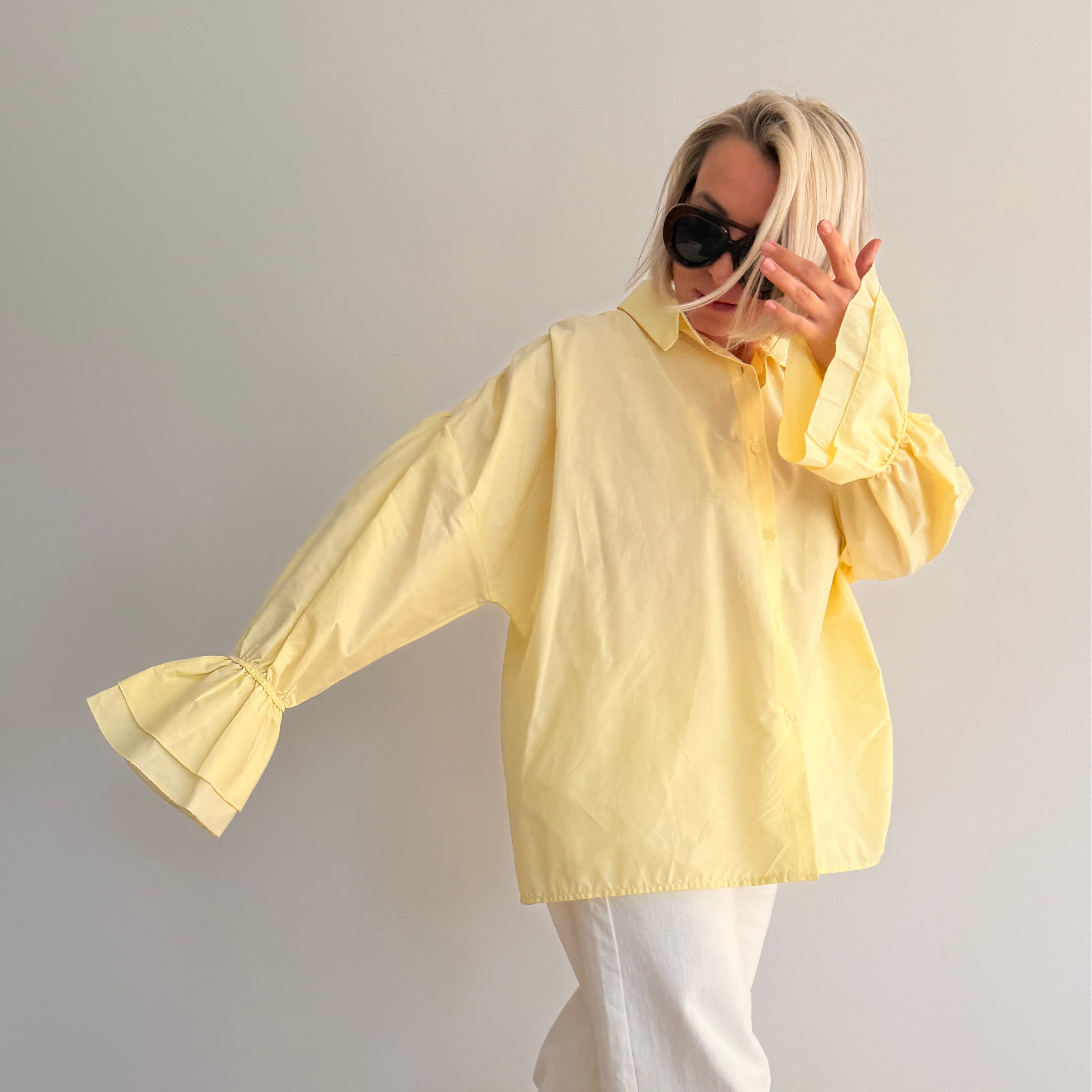 Chemise jaune pastel oversize à manches volumineuses portée avec jean large – look chic minimaliste femme